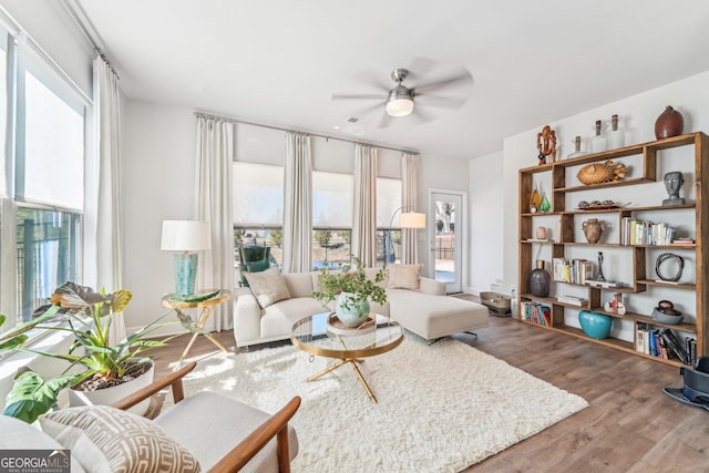 living room featuring ceiling fan and wood finished floors