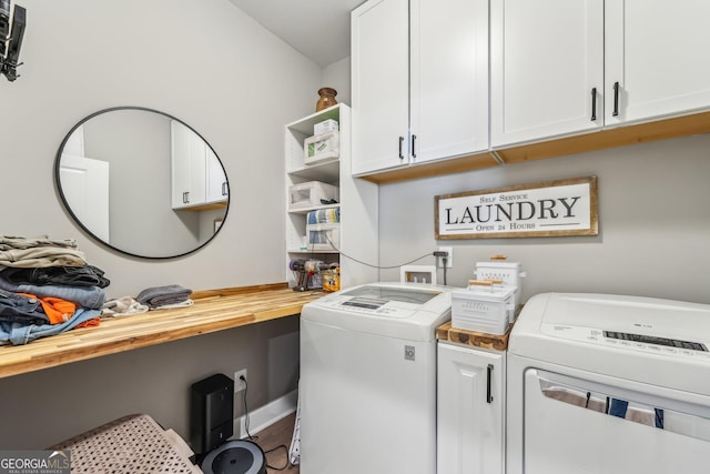 clothes washing area with cabinet space and separate washer and dryer