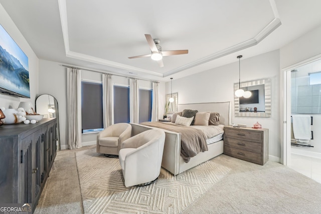 bedroom featuring baseboards, a raised ceiling, and light colored carpet