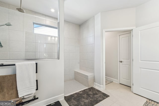 bathroom featuring tile patterned flooring, baseboards, and a walk in shower