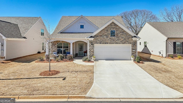 view of front facade featuring driveway, a garage, a shingled roof, stone siding, and a porch