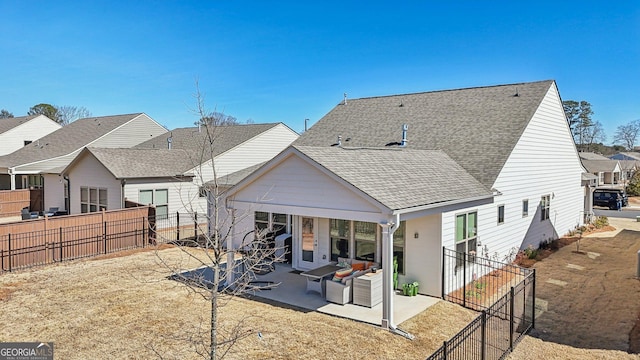 rear view of property featuring a patio area, a fenced backyard, a residential view, and roof with shingles