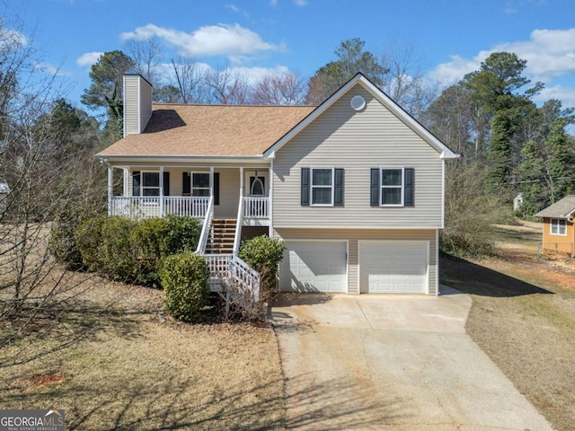 view of front of house featuring concrete driveway, a chimney, stairway, an attached garage, and a porch