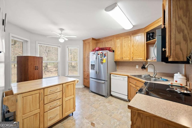 kitchen featuring open shelves, light countertops, a sink, dishwasher, and stainless steel fridge with ice dispenser