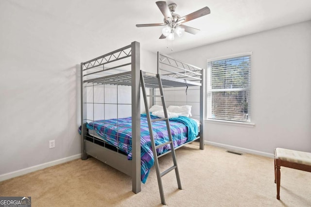 bedroom with carpet, visible vents, baseboards, and ceiling fan