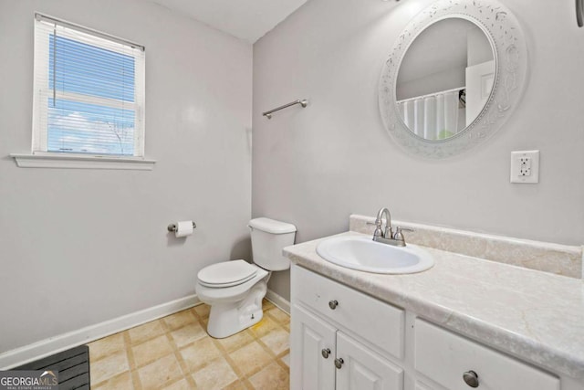 full bath with baseboards, vanity, and toilet