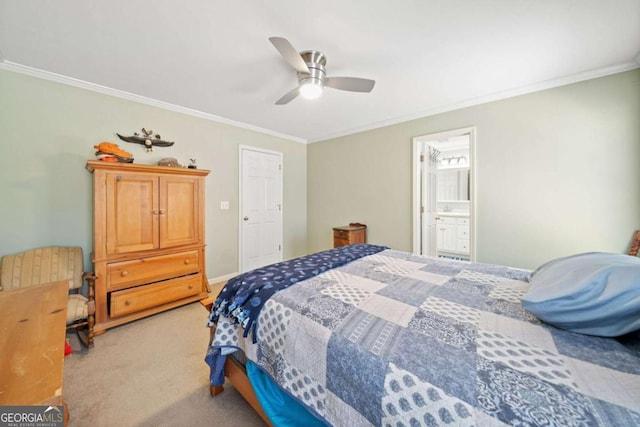 carpeted bedroom featuring ceiling fan, ornamental molding, baseboards, and ensuite bathroom