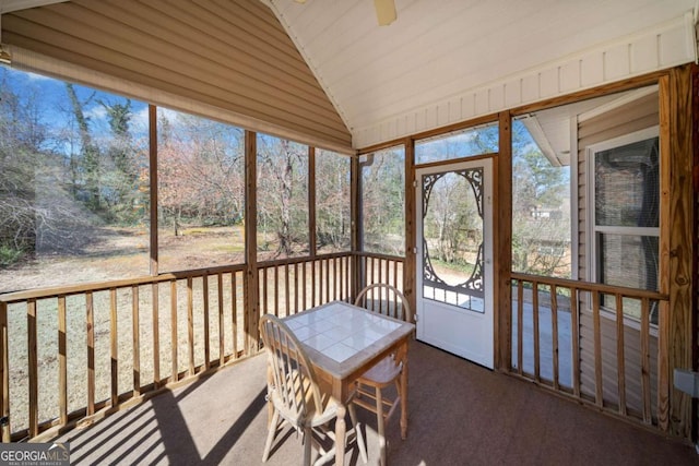 unfurnished sunroom featuring vaulted ceiling