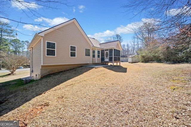 back of property with a sunroom