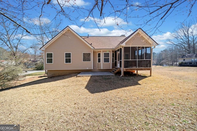 back of property with a sunroom and a lawn