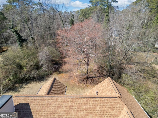 exterior space featuring a forest view