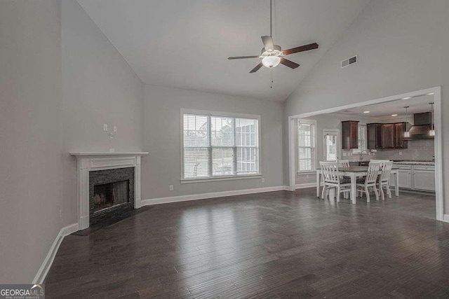 unfurnished living room featuring baseboards, a fireplace, visible vents, and dark wood-type flooring