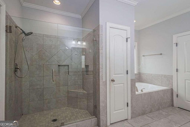 bathroom featuring ornamental molding, a stall shower, tile patterned flooring, and a garden tub