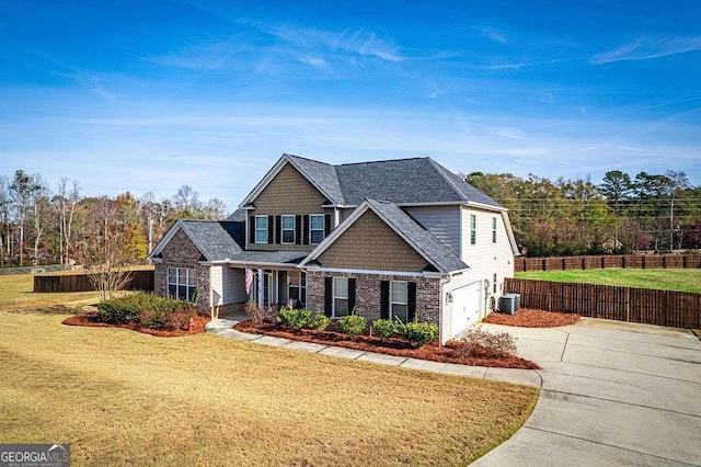 view of front of property featuring central AC unit, an attached garage, fence, driveway, and a front lawn