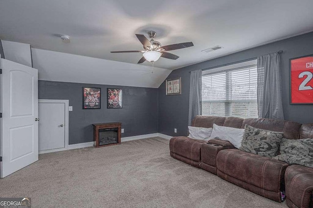 living area featuring visible vents, baseboards, vaulted ceiling, a ceiling fan, and carpet