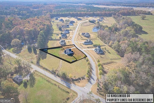 birds eye view of property with a rural view