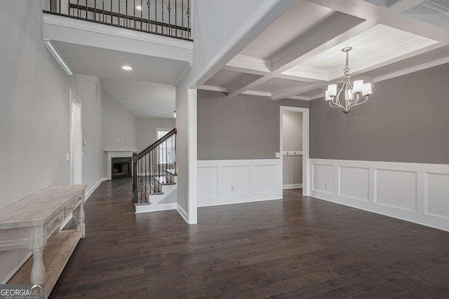 interior space featuring coffered ceiling, stairway, wood finished floors, beamed ceiling, and a fireplace