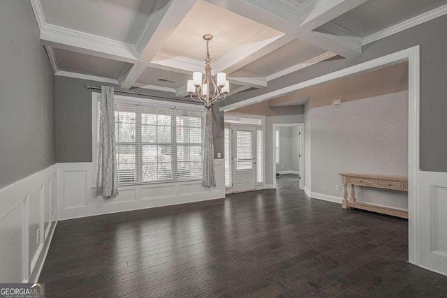 unfurnished room with a notable chandelier, crown molding, wood finished floors, coffered ceiling, and beamed ceiling