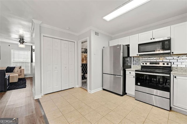 kitchen featuring visible vents, light countertops, ornamental molding, appliances with stainless steel finishes, and decorative backsplash