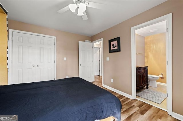 bedroom featuring a closet, wood finished floors, a ceiling fan, and baseboards