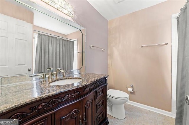 bathroom featuring curtained shower, vanity, toilet, and baseboards