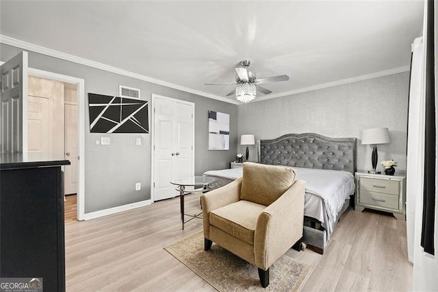 bedroom with ornamental molding, visible vents, light wood-style flooring, and baseboards