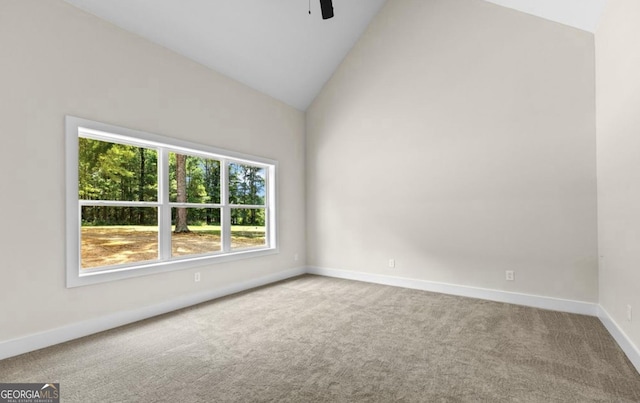 unfurnished room with a ceiling fan, baseboards, high vaulted ceiling, and carpet flooring