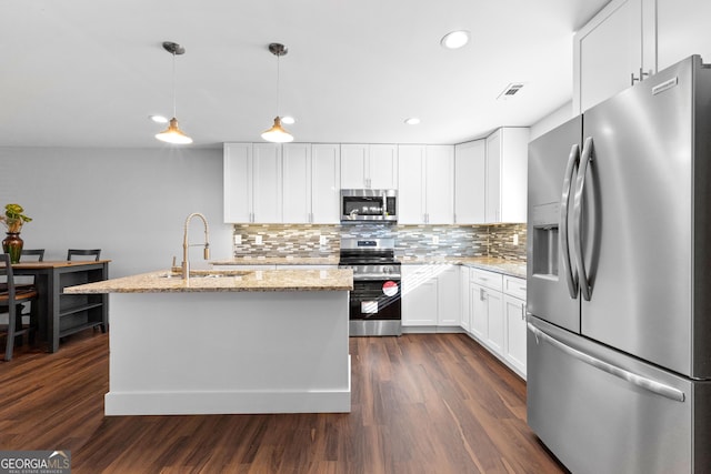 kitchen with a sink, visible vents, appliances with stainless steel finishes, light stone countertops, and dark wood finished floors