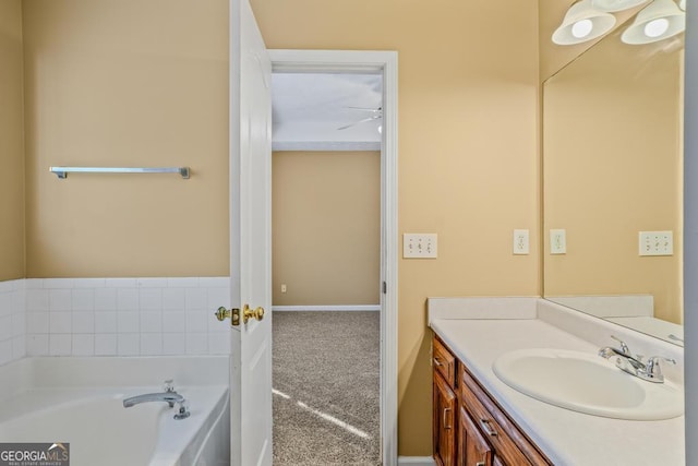 bathroom featuring a bath, vanity, and baseboards