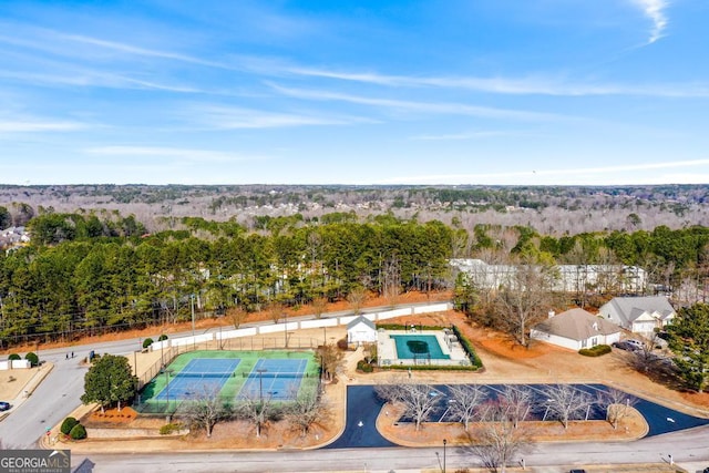 birds eye view of property featuring a view of trees