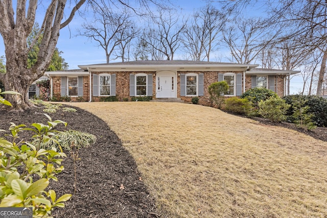 single story home featuring brick siding