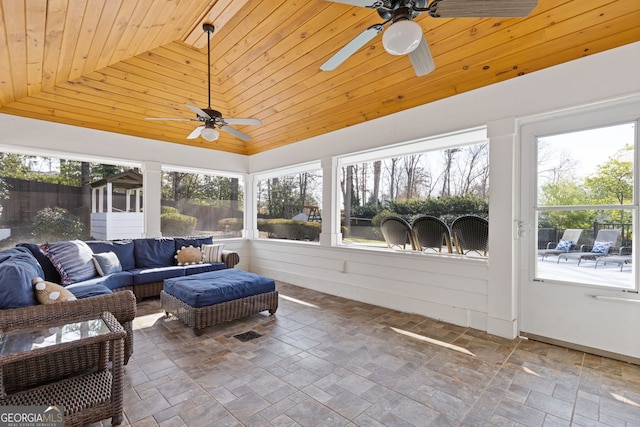 sunroom / solarium featuring wooden ceiling, lofted ceiling, and a ceiling fan