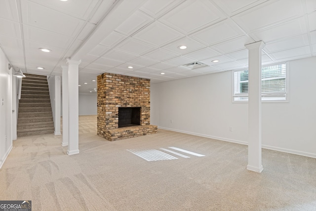 below grade area with visible vents, baseboards, carpet flooring, recessed lighting, and a fireplace