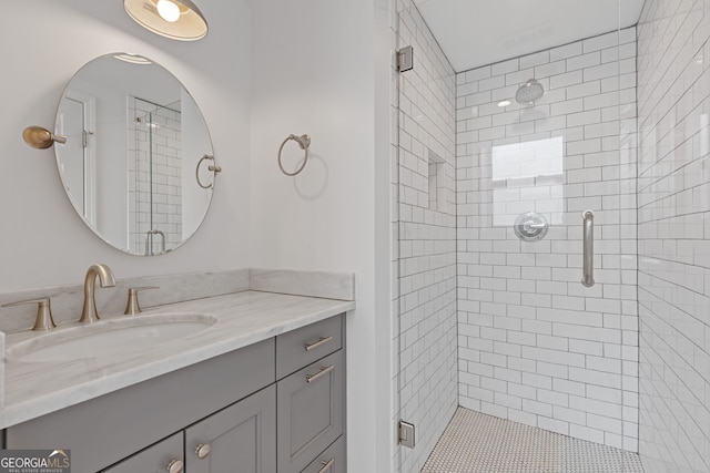 full bath with a stall shower and vanity