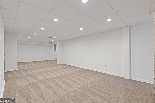 finished below grade area featuring recessed lighting, light colored carpet, and baseboards