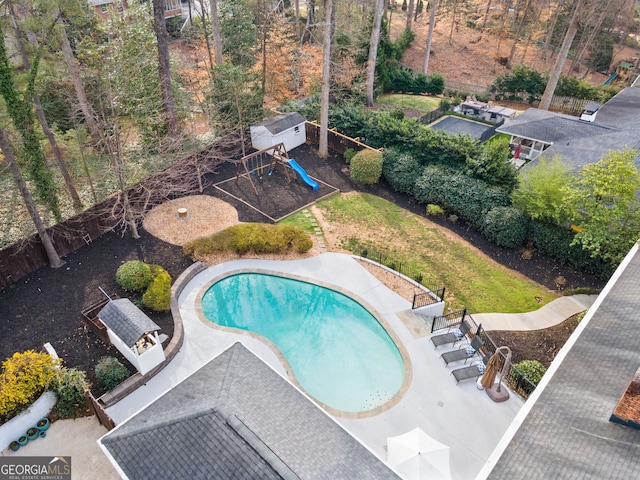 pool featuring fence and a playground