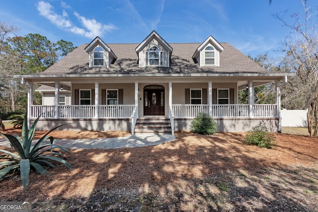 view of front facade featuring a porch and roof with shingles