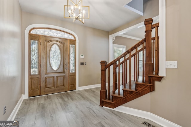 entryway with stairway, baseboards, and wood finished floors