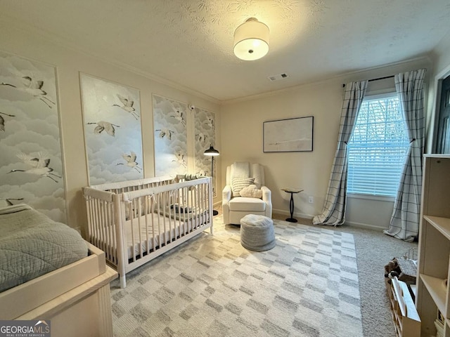 bedroom featuring carpet floors, crown molding, visible vents, a textured ceiling, and baseboards