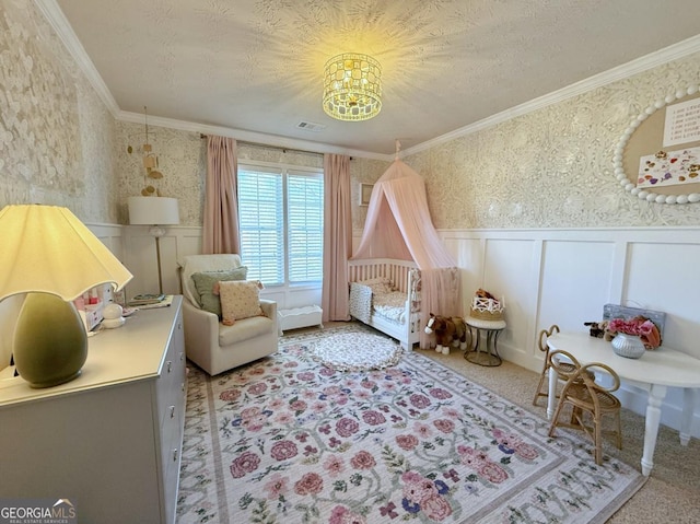 bedroom with a wainscoted wall, ornamental molding, and wallpapered walls