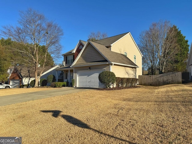 view of property exterior with a garage, concrete driveway, a yard, and fence