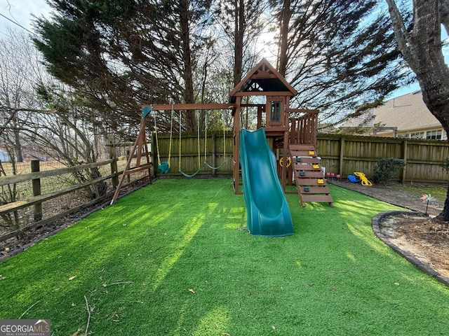 view of jungle gym with a yard and a fenced backyard