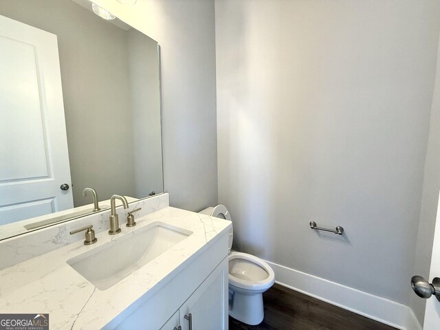 827 Winslow Way NW, Atlanta, GA 30318 - half bathroom with wood finished floors, vanity, toilet, and baseboards