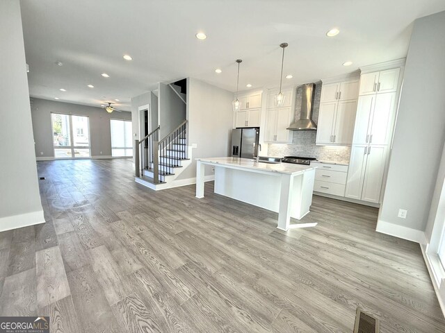 827 Winslow Way NW, Atlanta, GA 30318 - kitchen featuring visible vents, stainless steel fridge with ice dispenser, open floor plan, light countertops, and wall chimney range hood