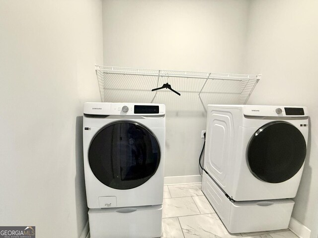 827 Winslow Way NW, Atlanta, GA 30318 - clothes washing area with marble finish floor, laundry area, washer and clothes dryer, and baseboards