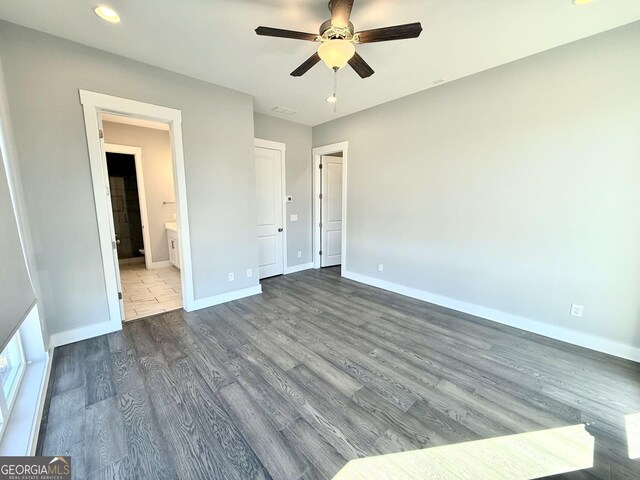 827 Winslow Way NW, Atlanta, GA 30318 - unfurnished bedroom featuring ensuite bathroom, ceiling fan, wood finished floors, visible vents, and baseboards