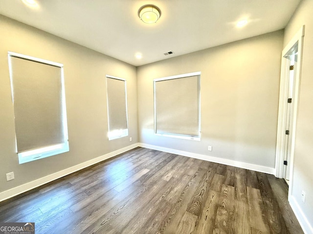 827 Winslow Way NW, Atlanta, GA 30318 - empty room with visible vents, dark wood finished floors, and baseboards