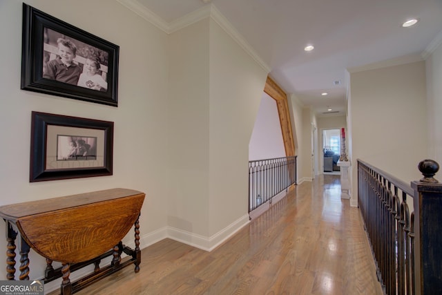 corridor featuring recessed lighting, crown molding, baseboards, and wood finished floors