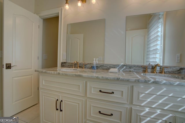 full bath featuring tile patterned flooring, a sink, and double vanity