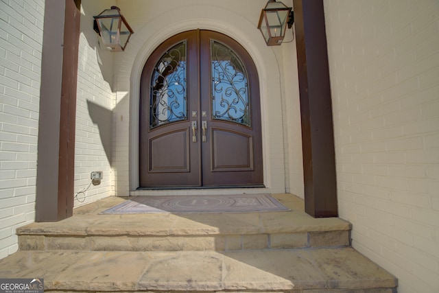 view of exterior entry featuring french doors